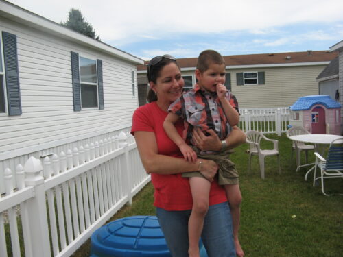 Darrian being held by his mom in their backyard.